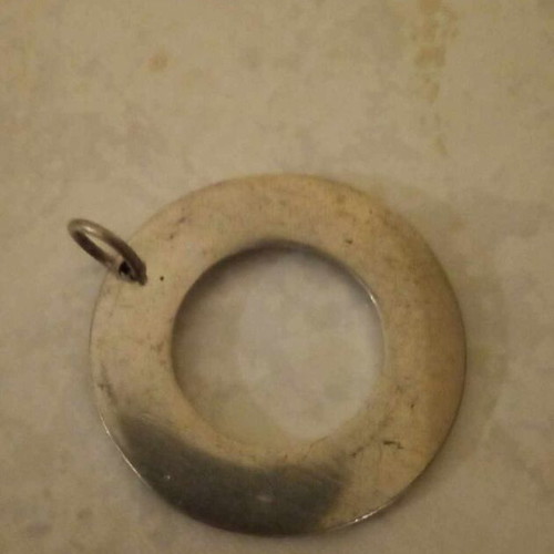 Silver pendant used with engraved quote