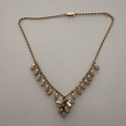 Vintage necklace with embossed white and gold decorations