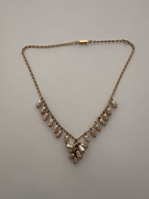 Vintage necklace with embossed white and gold decorations