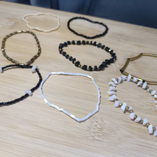 Set of elastic bracelets with assorted beads in black, white and gold