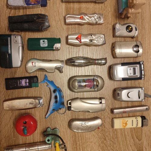 Collection of 25 used vintage lighters and 3 matchboxes from hotels and restaurants