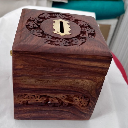 Wooden coin box with brass clip and carved design