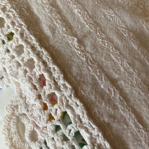 Woven cotton bedspread used with handmade lace trim