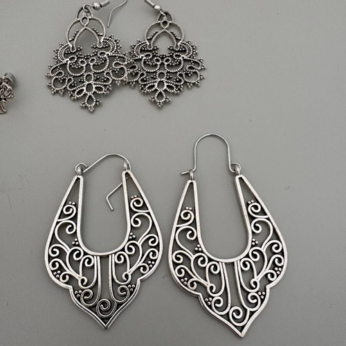 Earring set like new, 3 pairs dangle and 1 pair stud, silver color