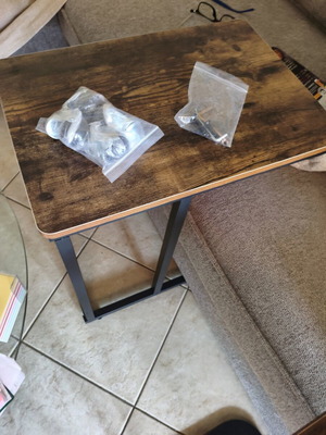 Wooden side table with metal base and wheels