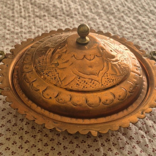 Traditional copper vessel with carved lid used