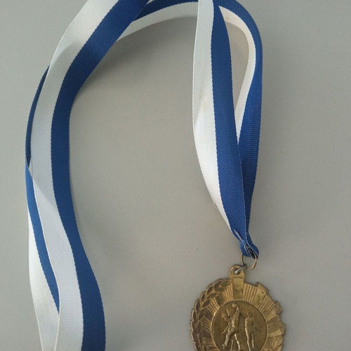 Gold basketball medal like new with blue and white ribbon