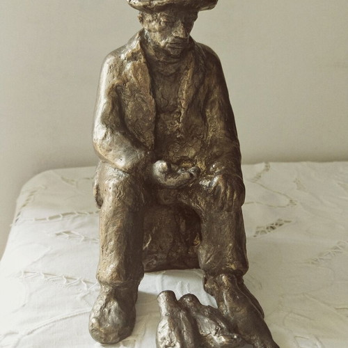 Realistic sculpture of an elderly man feeding pigeons, new