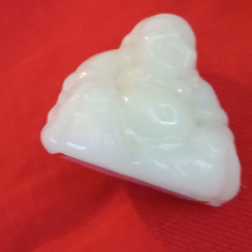 Alabaster-style miniature Buddha, smiling