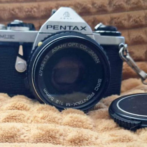 Asahi Pentax ME (1981) camera with 50mm lens and worn leather case