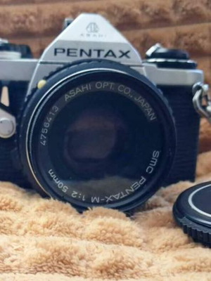 Asahi Pentax ME (1981) camera with 50mm lens and worn leather case
