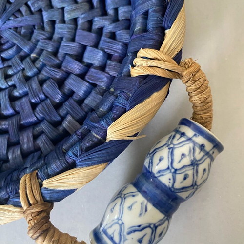 Blue handmade wicker basket with painted porcelain handles like new