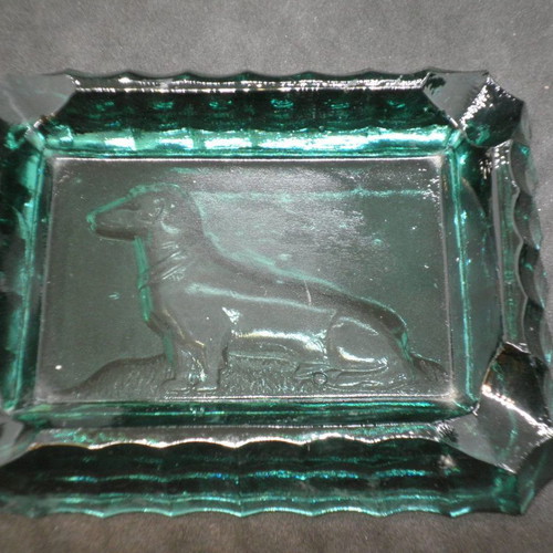 Antique ashtrays pair used with embossed dogs in dark green glass