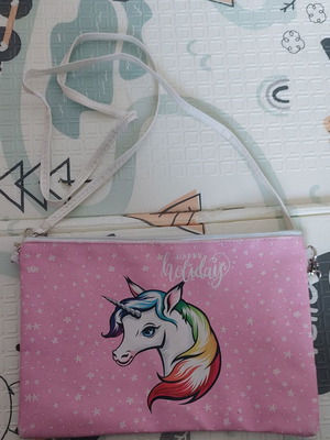 Pink shoulder clutch bag used with unicorn design