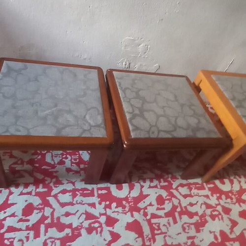 Wooden side tables with plastic protection and decorative fabric