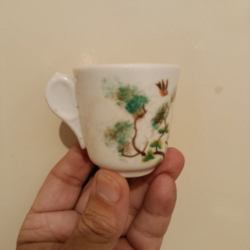Vintage porcelain cup with bird design