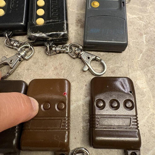 Garage door remotes used, set of 10, one broken with tape
