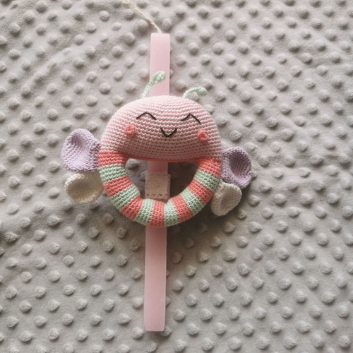 Candle with knitted butterfly rattle