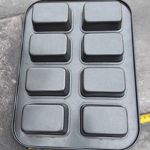 Nonstick baking pan with 8 rectangular molds for mini cakes and buns