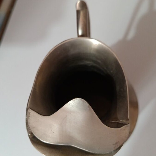 Vintage metal pitcher used with hinged lid and embossed handle