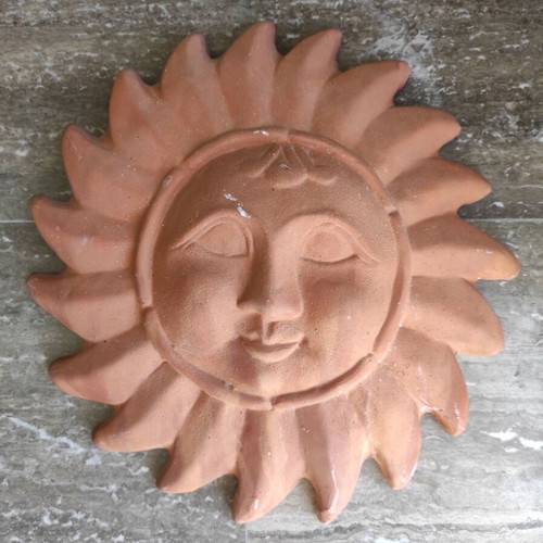 Clay wall decorative depicting the Sun in human form