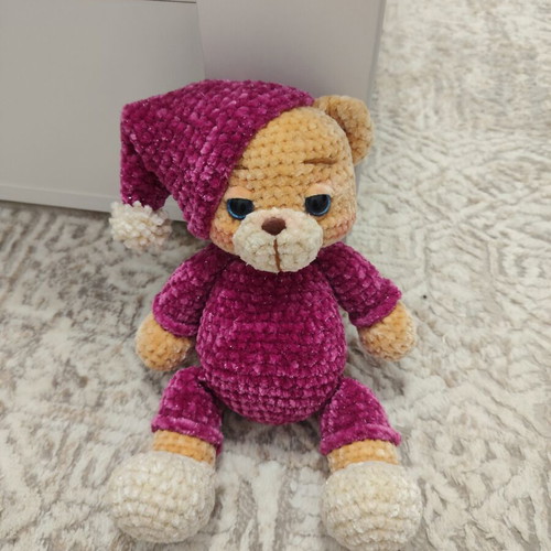 Amigurumi knitted teddy bear with velvet pajamas and sleep hat
