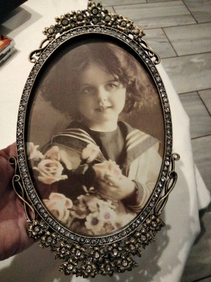 Oval metal frame with flower design and decorative crystals like new