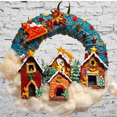 Handmade wreath Santa Claus with sleigh in Christmas village lit with LED