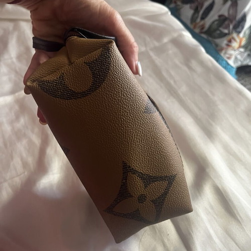 Small toiletry bag like new, brown, with zipper and wrist strap