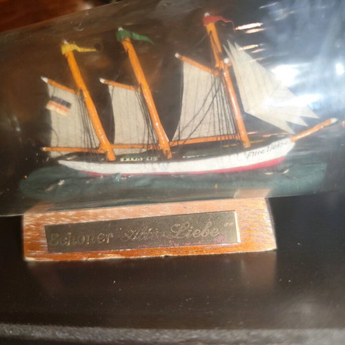 Ship in a bottle used with sealed top and wooden base