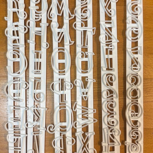 Decorative style letter cutters set like new, 25x3cm