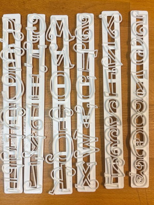 Decorative style letter cutters set like new, 25x3cm