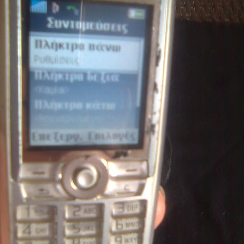 Sony Ericsson K700i used mobile phone with charger and headphones