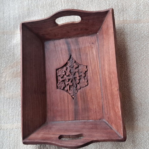 Vintage wooden serving tray used with carved floral motif