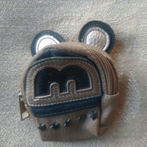 Coin purse used in mini backpack shape with decorative ears and letter M