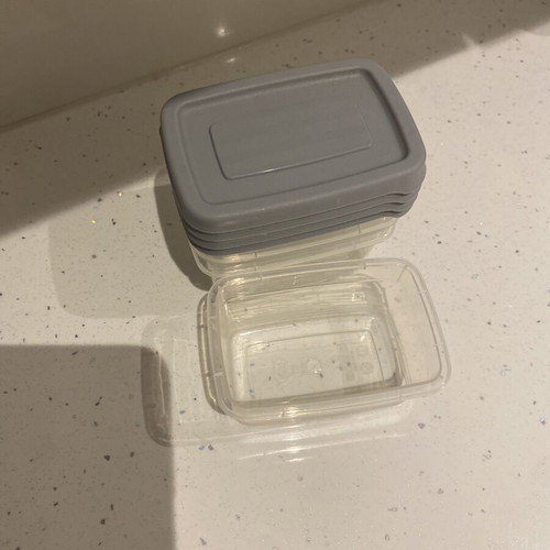 Set of small plastic food storage containers