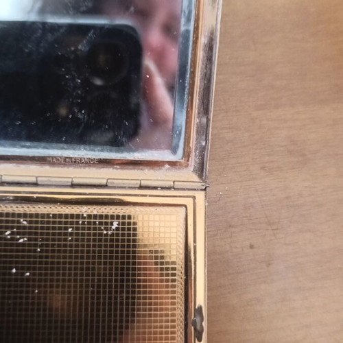 Compact powder with mirror used, black and gold design