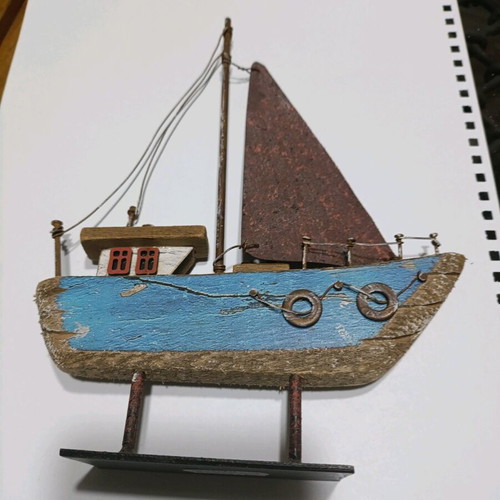Wooden boat with metal sail unused