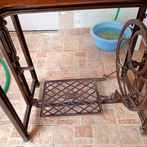 Antique sewing machine used with furniture and accessories