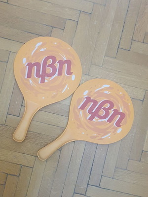 Wooden rounded beach paddles, orange