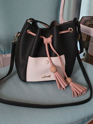 Axel crossbody bag black with white pocket and pink tassels
