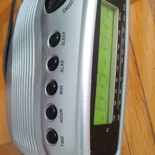 Digital alarm clock used with radio and minor display lines