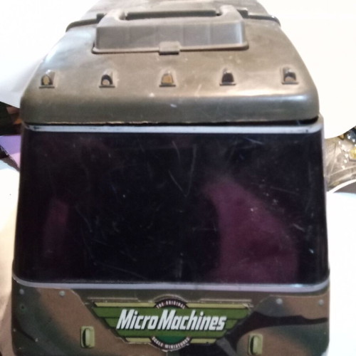 Micro machine military vehicle hiding a small city like new