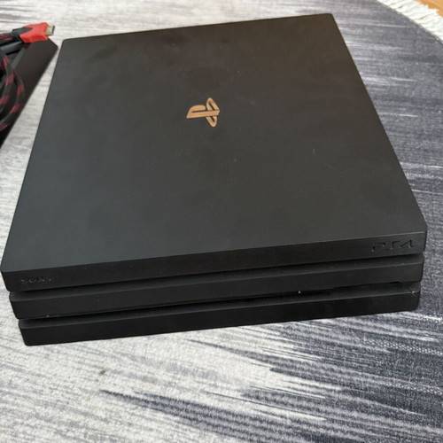 Sony PlayStation 4 Pro 1TB console used with controllers and charging dock