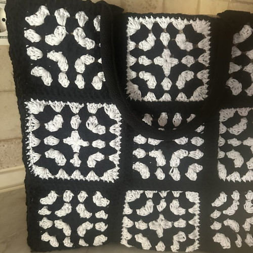Handmade jute bag with black and white crochet motifs