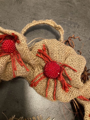 Christmas wreath made of natural materials with knitted handle