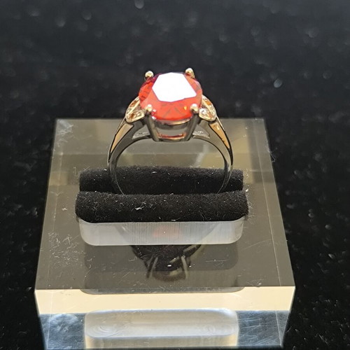 Ring with Large Red Ruby-Colored Stone and Decorative Stones