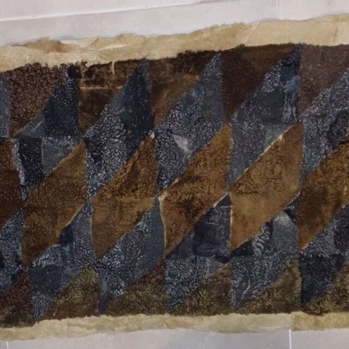 Handmade fur patchwork rug used in earthy tones