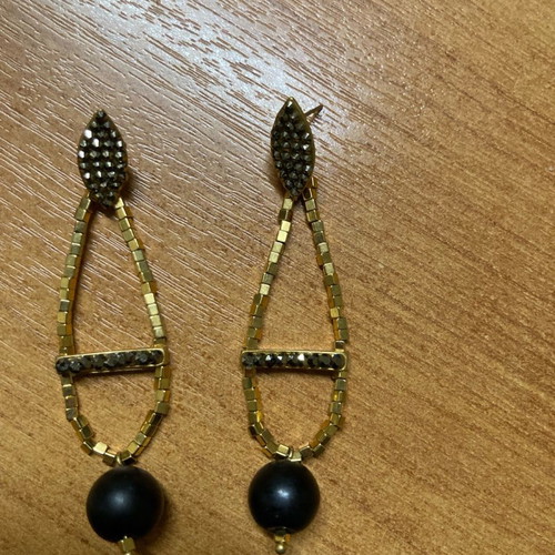 Earrings with beads used, gold and black color