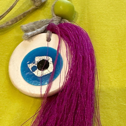 Necklace with clay eye used, handmade with fuchsia tassel